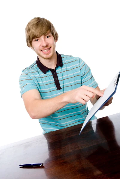 The young man points a finger at a blank sheet of sitting at the — Stock Photo, Image