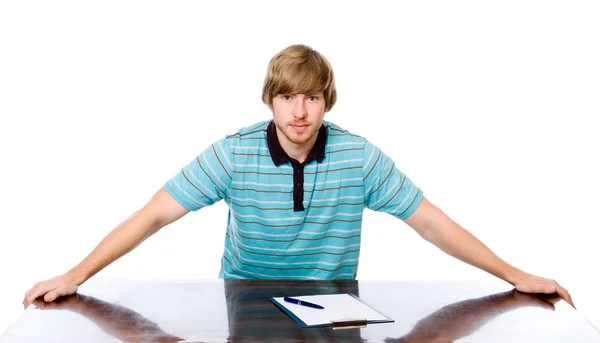 Portret młodego mężczyzny siedzi za biurkiem. — Zdjęcie stockowe