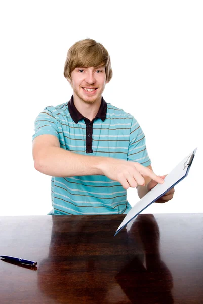 The young man points a finger at a blank sheet of sitting at the — Stock Photo, Image