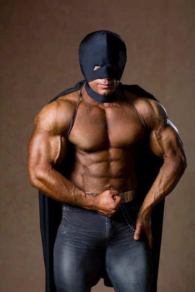 Strong muscular man in black mask — Stock Photo, Image