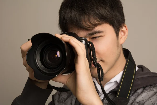 Portrait of photographer using professional camera — Stock Photo, Image