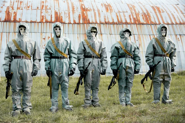 A group of soldiers with guns in their masks and protective clot — Stock Photo, Image