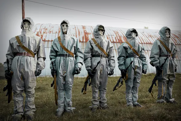 A group of soldiers with guns in their masks and protective clot — Stock Photo, Image