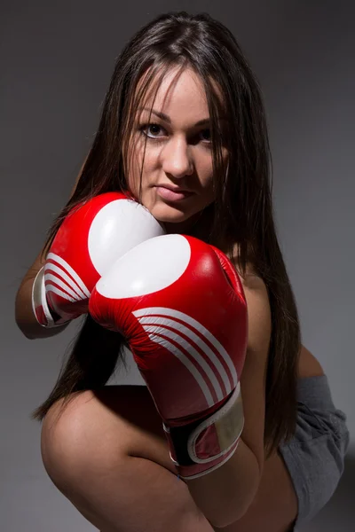 Girl with boxing gloves, dark hair. — Stock Photo, Image