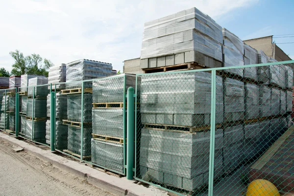 Packed cinder blocks outdoors in racks. — Stock Photo, Image