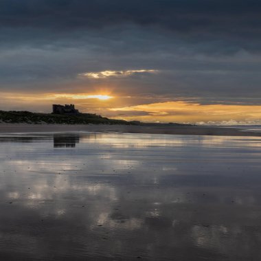 Bamburgh Castle from the beach to the south at sunset with no people