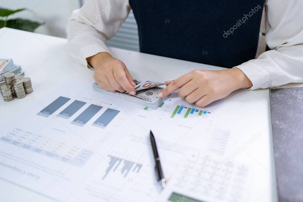 Businesswoman Accountant analyzing investment charts Invoice and pressing calculator buttons over documents. Accounting Bookkeeper ClerkBank Advisor And Auditor 