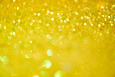 Altın parıltının bulanık dokusu. Altın parıltılı arka plan ya da sarı pullu. Sarı altın pullu pürüzsüz bir doku. Titrek arkaplan.