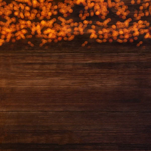 テキストのためのコピースペースを持つ木製の茶色の背景にぼっしょりライト — ストック写真