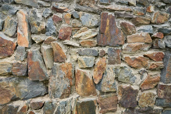 En detaljerad bild av en stenmur. Gammal sten vägg struktur bakgrund för design och inredning. — Stockfoto