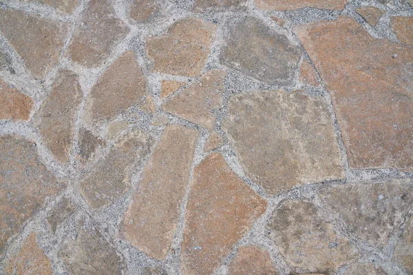 Superficie de camino de piedra vieja naranja. Textura sin costuras. La textura de un camino de piedra — Foto de Stock