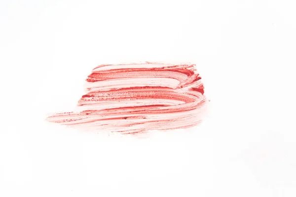Smeden och konsistensen av läppstift. Den rosa färgen markeras på en isolerad vit bakgrund. Ett element för skönhetskosmetisk design. — Stockfoto