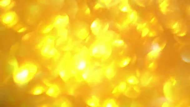 Quick movements of the flickering background. Blurred texture of golden radiance. Seamless texture with yellow gold sequins. — Stock Video