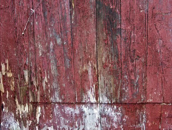Panneau en bois avec une vieille peinture rouge — Photo