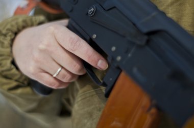 ormanda silahlı askeri üniformalı kadın