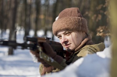 ormanda silahlı askeri üniformalı kadın