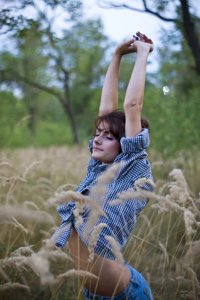 Flicka som poserar i gräset — Stockfoto