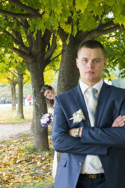 O noivo e a noiva no passeio no parque de outono — Fotografia de Stock