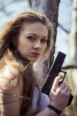 Otomatik saldırı tüfeği tutan güzel genç kadın