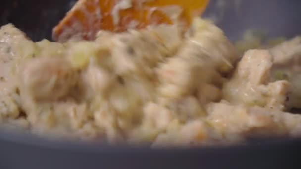 Kalkonfilé med grädde, stekt i stekpanna. Bitar kött och hackad lök. Närbild — Stockvideo