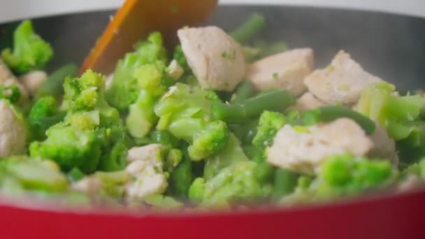 Stekt kycklingfilé med blandade stekta grönsaker i en stekpanna för servering. Långsamma rörelser — Stockvideo