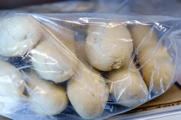 frozen bread in the supermarket refrigerator. Sale of ciabatta, loaf, hamburger buns