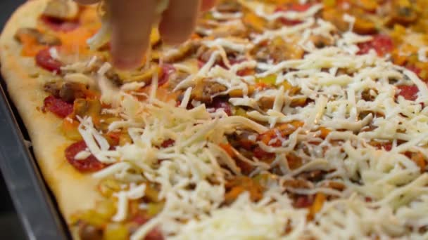 Chef making the pizza. Close-up. Adding cheese on pizza base. Slow motion — Stock Video