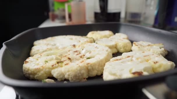 Raw slices of cauliflower in frying pan. Cooking cauliflower steak. Grill pan — Stock Video