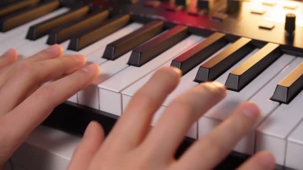 Male hands playing on piano electronic keyboard. Musician producing song at home recording studio. Selective focus — Vídeos de Stock