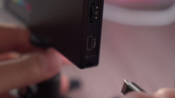 Hand holding USB type C cables to connect or disconnect. Selective focus — Stock Video