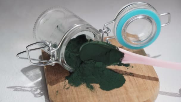 Green spirulina, spirulina powder with spoon. Useful habits, self care and healthy lifestyle. — Stock video