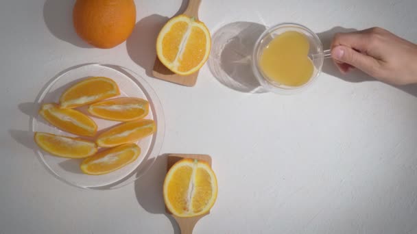 Orange juice in glass and fresh citrus fruits around. Orange juice. View from above. Flat lay — Vídeo de stock