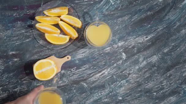 Oranges and juice glass on stone background. Top view with copy space — Stock Video