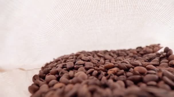 Coffee beans close-up in a bag, wide shooting angle. Selective focus — Wideo stockowe