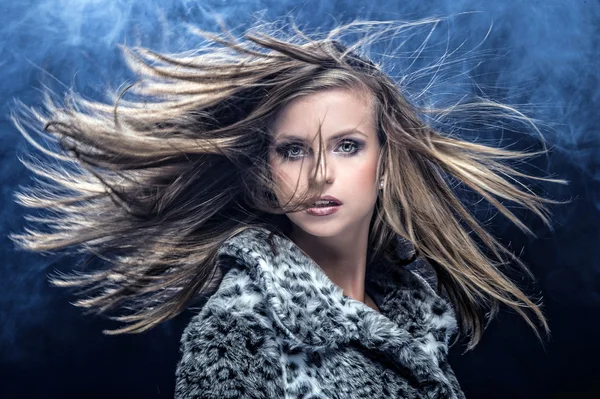 Portrait of pretty young woman flinging long blonde hair — Stock Photo, Image