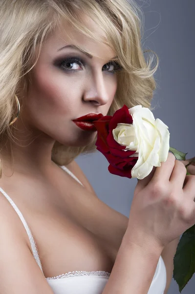 Close-up portrait of beautiful blonde woman with red - white ros — Stock Photo, Image