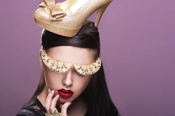 Sexy woman woth gold shoe on head — Stock Photo, Image