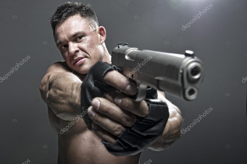 Armed Male In Military Uniform Holding Machine Gun And Posing At Camera.  Stock Photo, Picture and Royalty Free Image. Image 71968102.