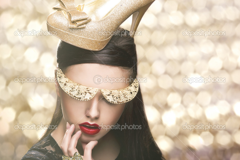 Download - Sexy woman woth gold shoe on head - Stock Image. 
