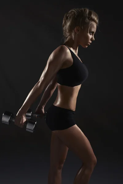 Sexy žena, která dělá fyzické cvičení s činkami — Stock fotografie