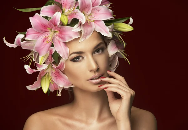 Studio portrait of beautiful blonde with blue eyes wearing flowers in her hair — Stock Photo, Image