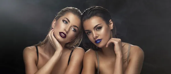 Two beauty ladies together. Wet hair and violet lips. — Stock Photo, Image