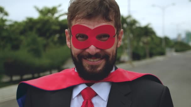 Портрет позитивно улыбающегося профессионального бизнесмена в красном плаще и очках Супергероя. Счастливый уверенный красивый взрослый бизнесмен, лидер, менеджер, выдающий себя за супергероя. — стоковое видео