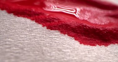 Kırmızı kan kavramı. Kırmızı kan beyaz bir beze damlıyor, kan beyaz bir kağıt peçeteye emiliyor, makro çekim..