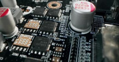 Macro dolly shot side view of a computer electrical circuit with cip, slots, microchip and microprocessors, black board with transistors and microchips. Close up detail of electronic components on PC