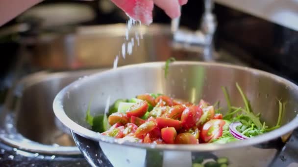 Greek Salad Preparation Series Concept Woman Salting Chopped Vegetables Glass — стоковое видео
