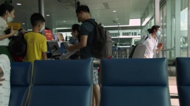 Coronavirus 'a karşı maskeli insanlar uçuş kontrolünden geçer ve Ho Chi Minh Havaalanı, Asya, Saigon, Vietnam, 5 Nisan 2022.