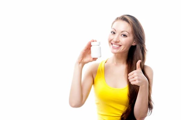 Asian girl with a jar of pills on a white background — Stock Photo, Image