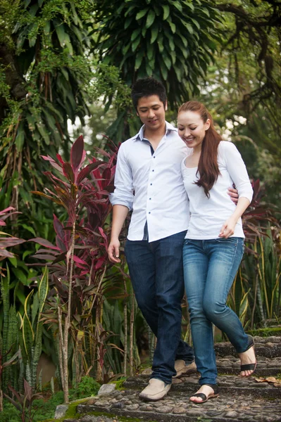 Asian couple walking on the park path — Stock Photo, Image