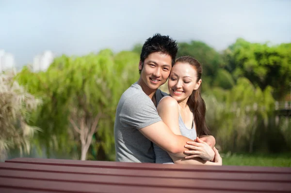 Asian couple hugging in the park — Stock Photo, Image